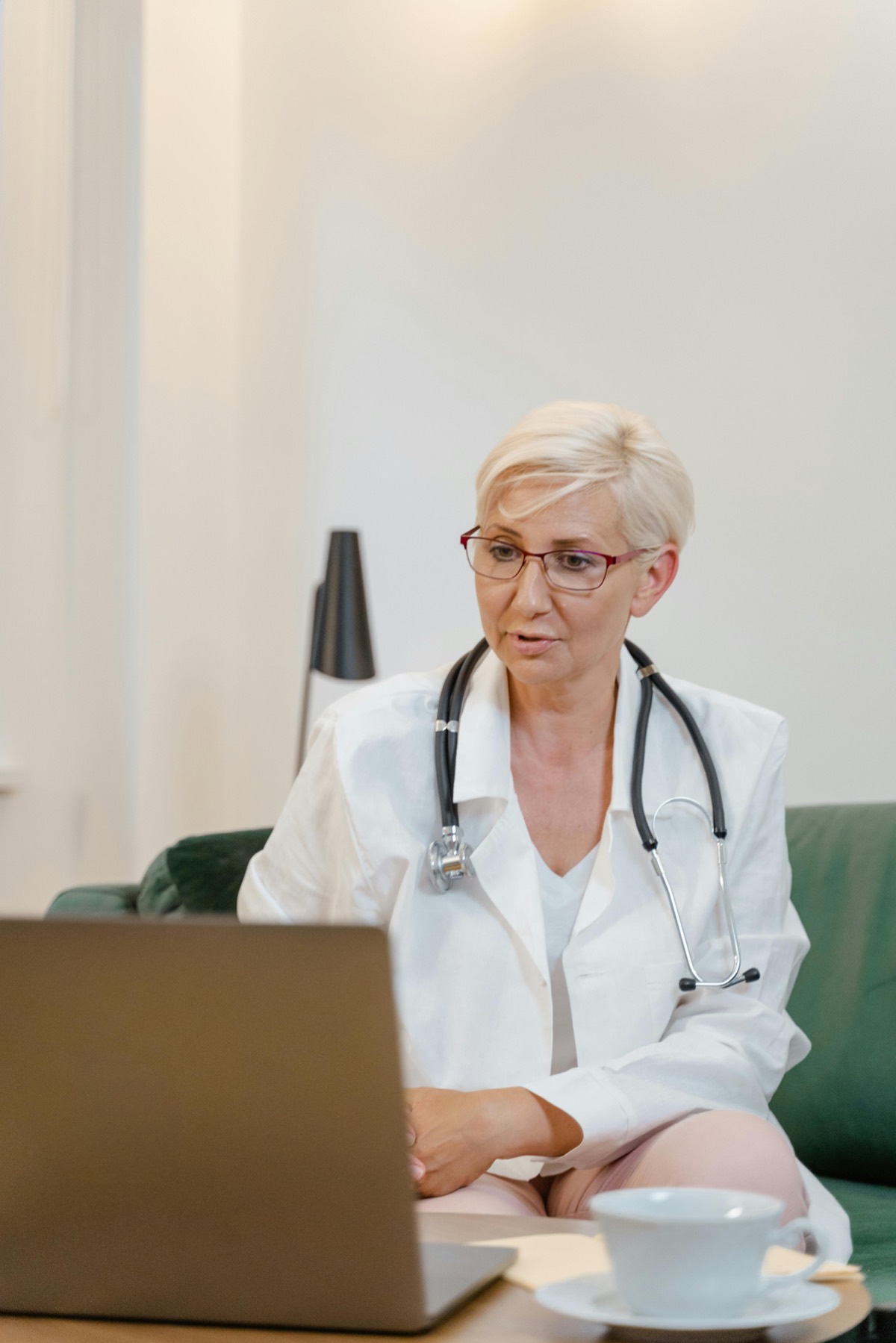 Physician reviewing a patient chart on a laptop